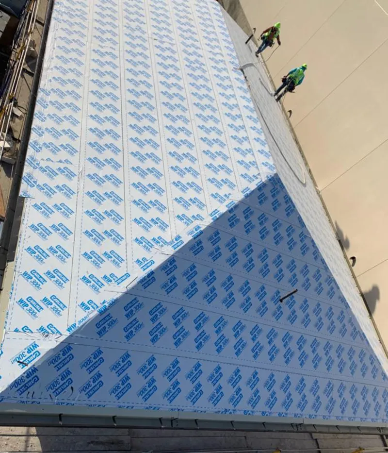 Professional roofers installing underlayment on a metal roof in Seymour